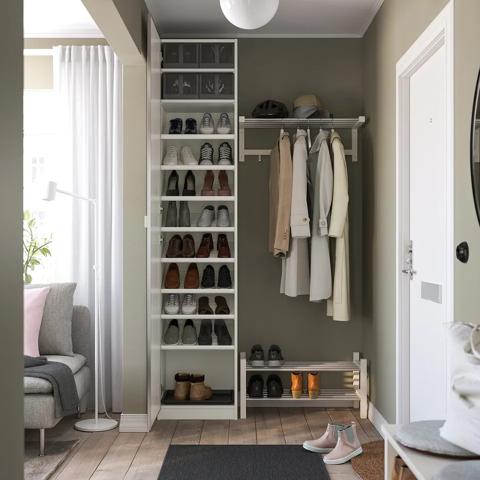 Well-organized entryway with shoe storage shelves and coat rack, featuring a modern design and efficient use of space.