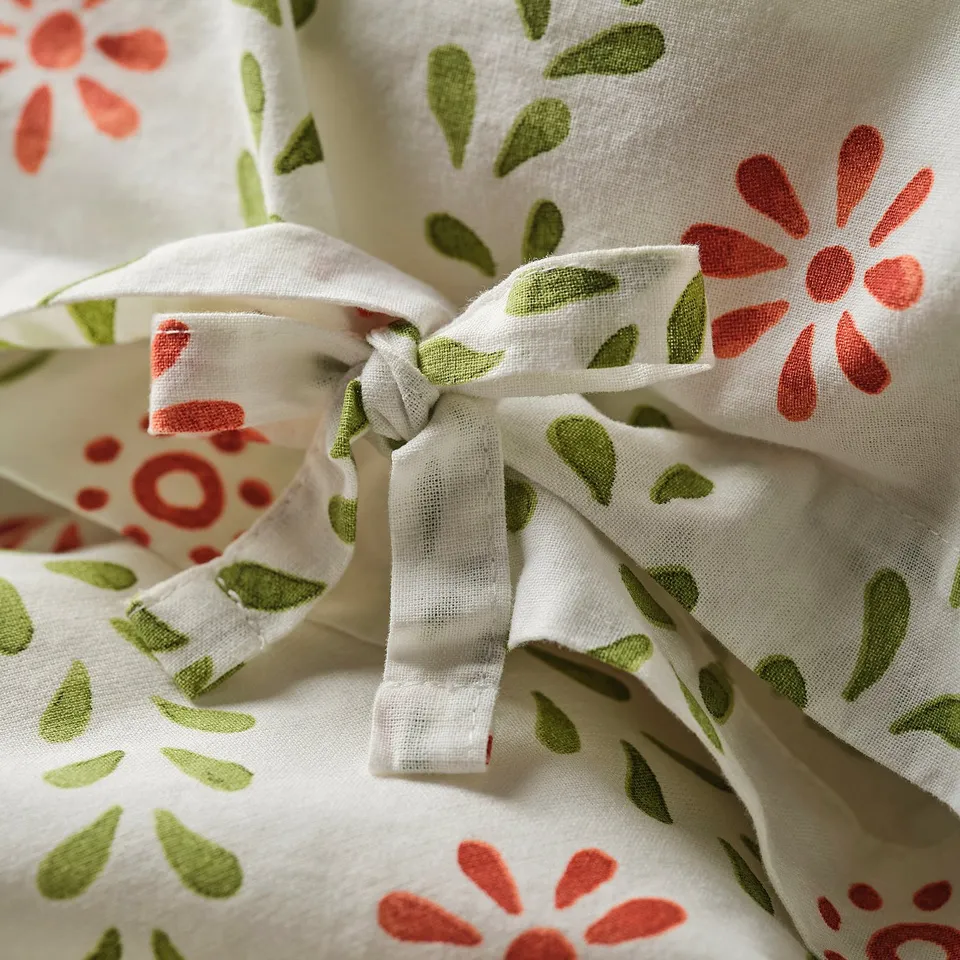 Floral duvet set with ties, showing bow detail. 100% soft, breathable cotton.