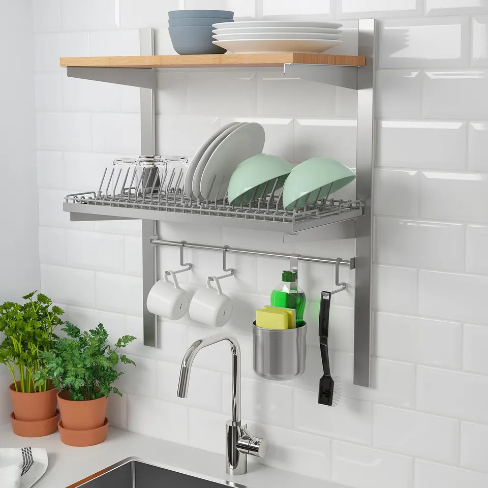 Wall-mounted dish rack and storage system in kitchen. Holds dishes, cups, and cleaning supplies near sink.