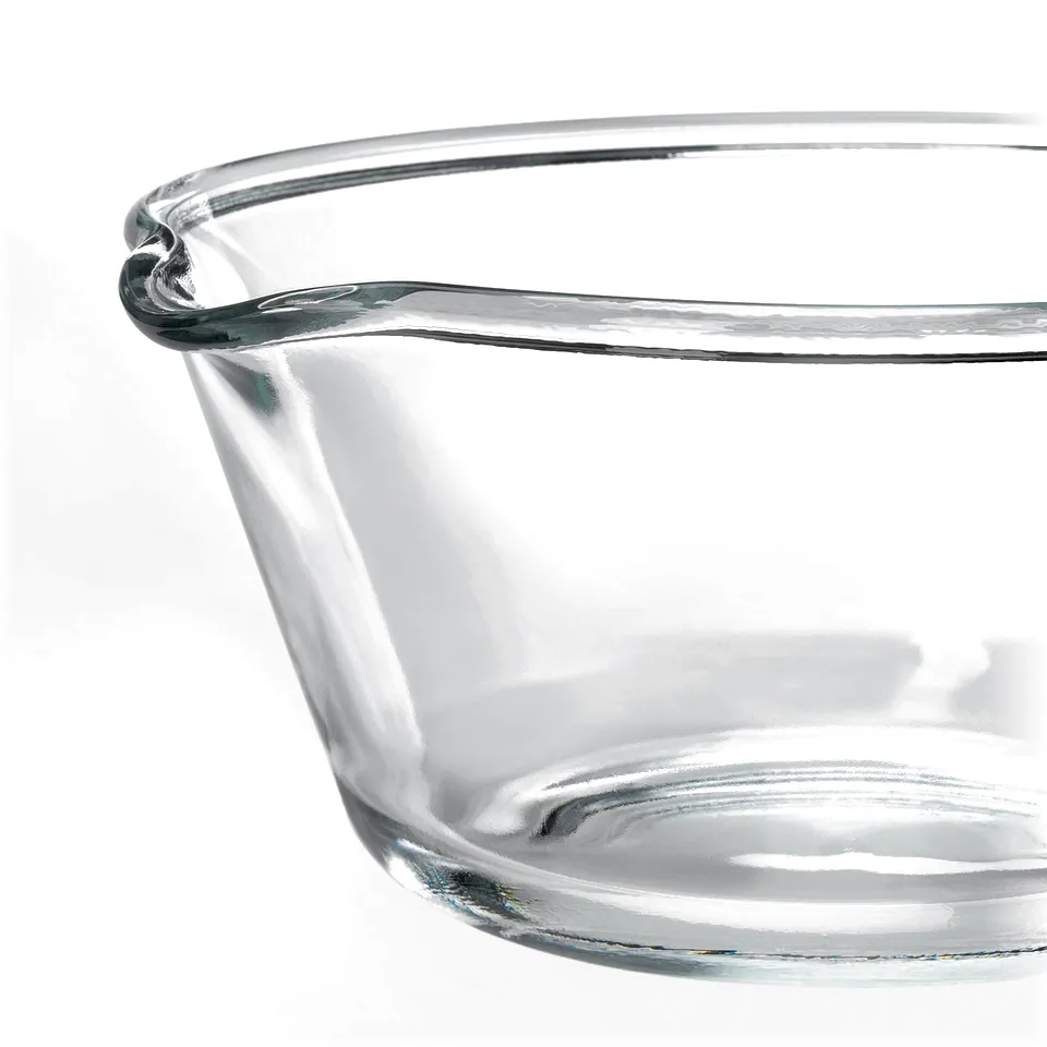 Clear glass bowl with smooth, rounded edges and a spout, shown against a white background.