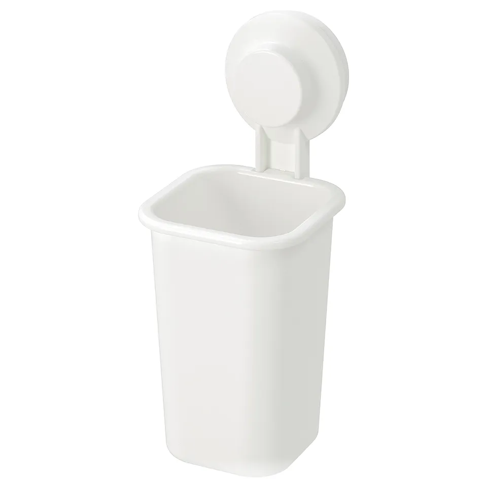 A white TISKEN wall-mounted container with a suction cup. Its rectangular, with smooth edges, designed to hold small items.