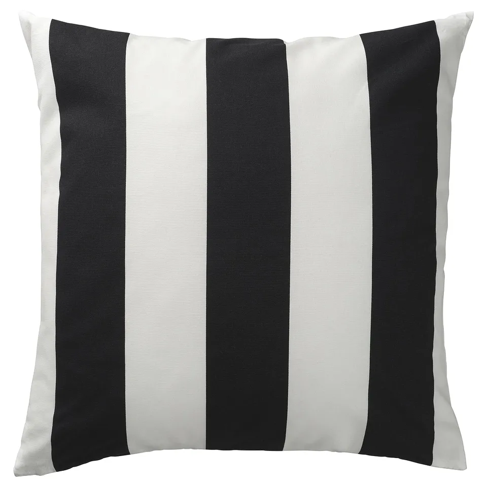 A square SLÅNHÖSTMAL pillow with black and white stripes, featuring a hidden zip and made of recycled cotton.