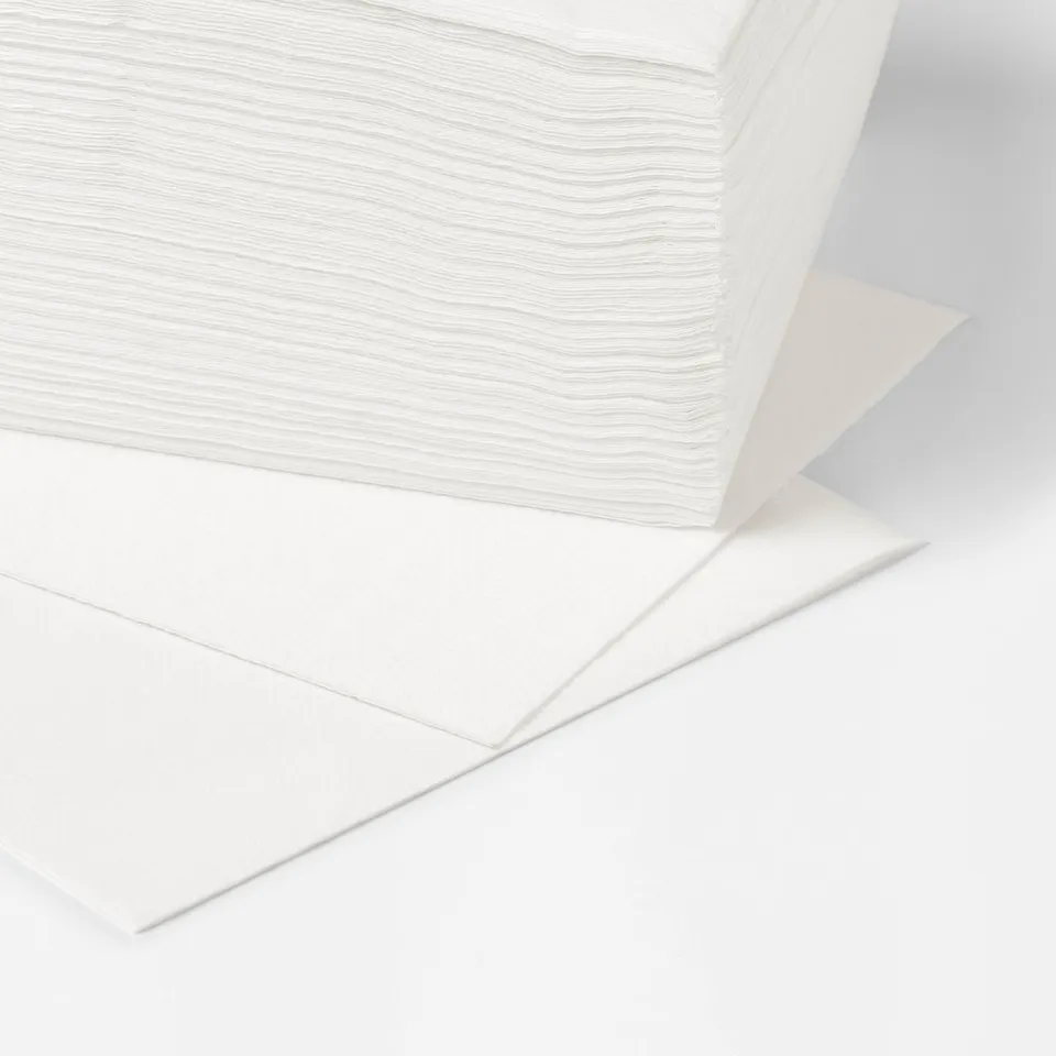 Large stack of pristine white napkins, neatly folded, ideal for various table settings.