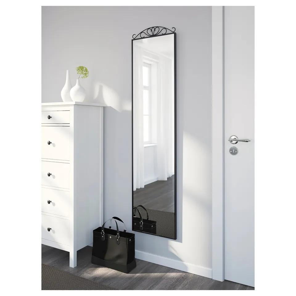 Minimalist room with mirror reflecting doorway, handbag on dresser, tomorrows outfit.