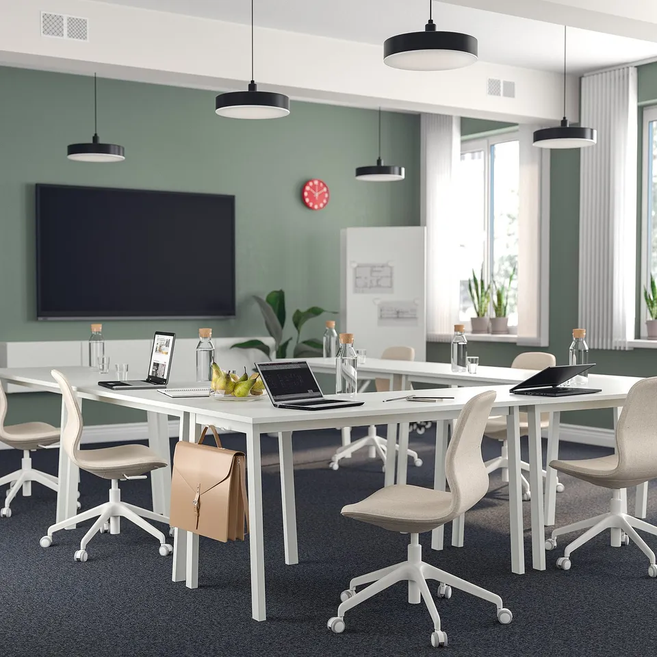 MITTZON conference room: minimalist with white tables, green walls, tech, and fruit.