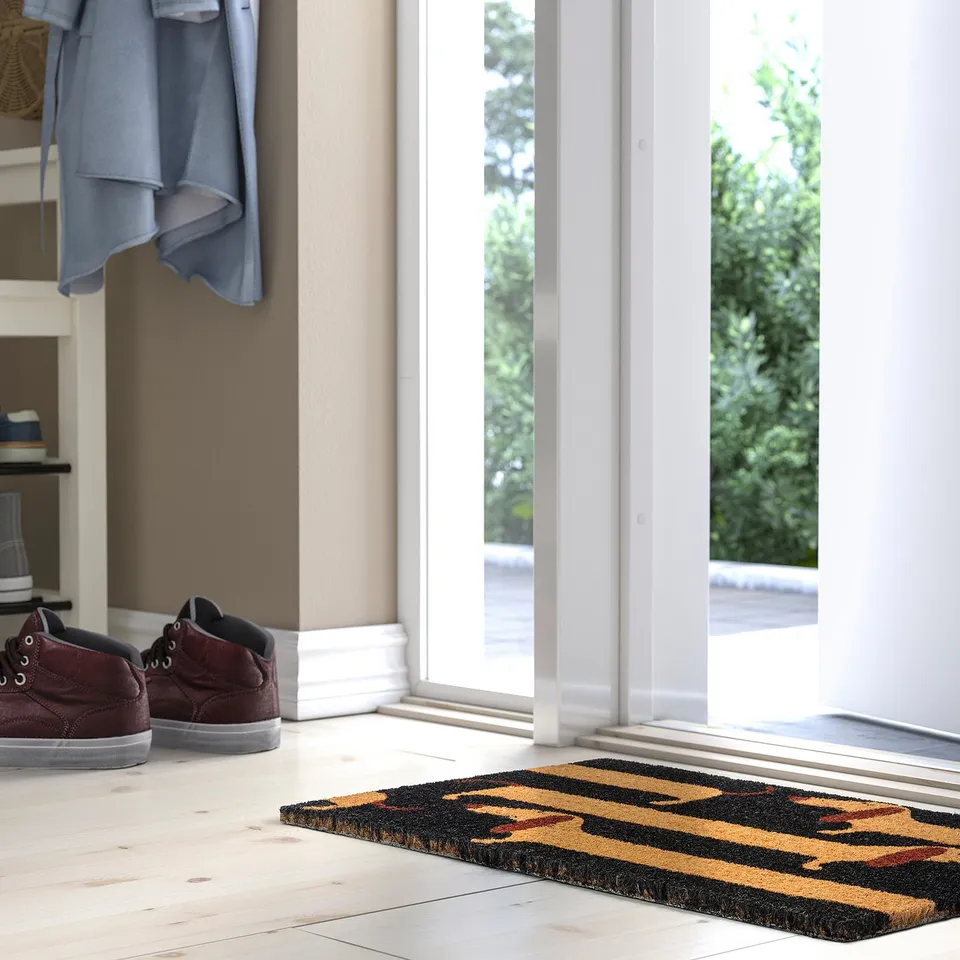 ARBETSTÅG doormat: black, yellow stripes, red paw prints, fits entryway.