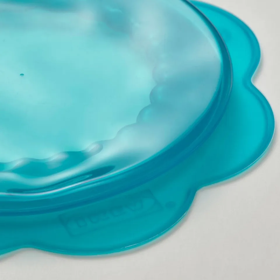 Blue silicone bowl, smooth texture, soft edges, perfect for food storage.