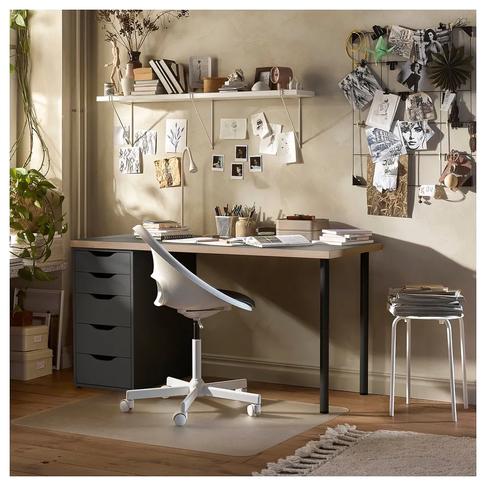 Desk setup with drawers, chair, and shelves. Modern design, light wood, white accessories. Inspiring, organised workspace.