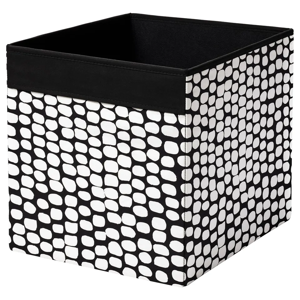 Black & white dot patterned square fabric storage box with handles.