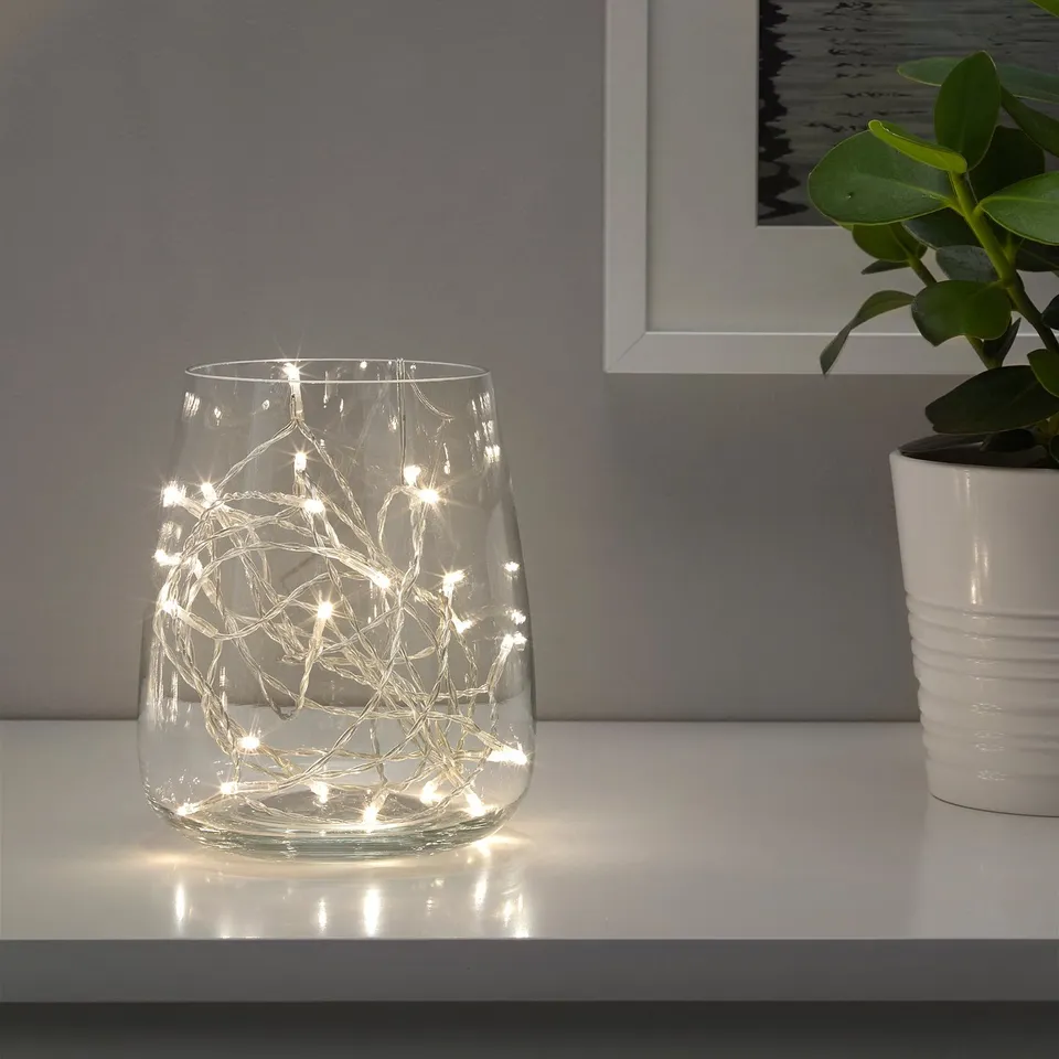 Clear glass vase with warm white led lights, creating decorative indoor ambiance.