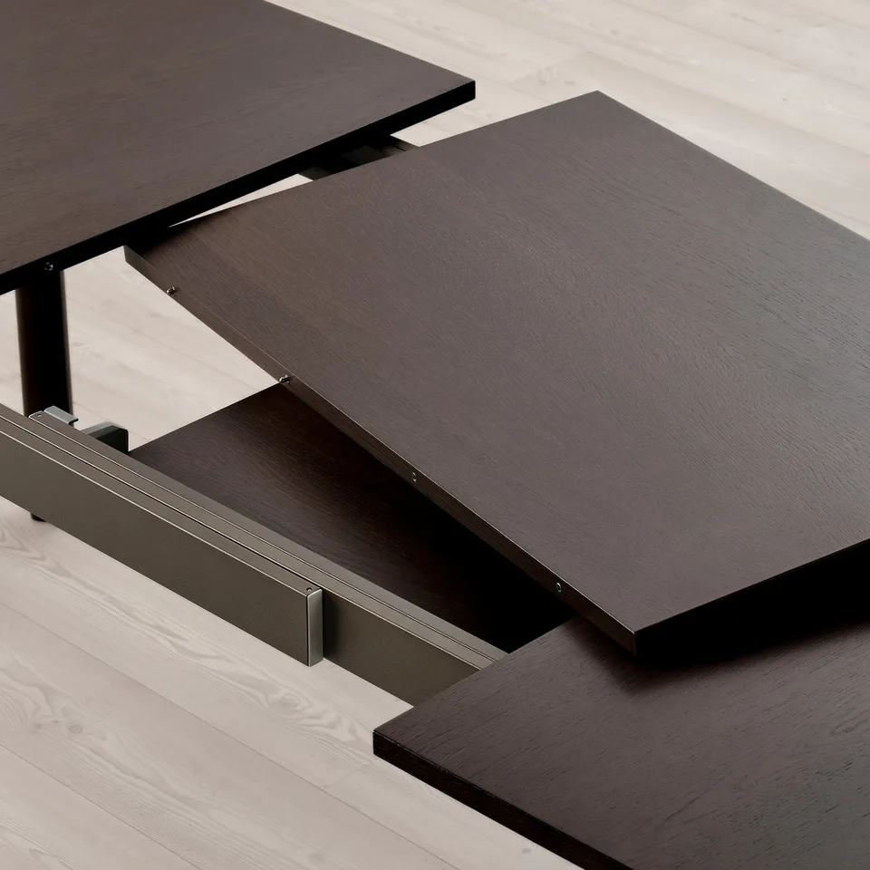 Dark wood dining table with extendable leaves, supported by metal legs, displayed on light wooden floor.