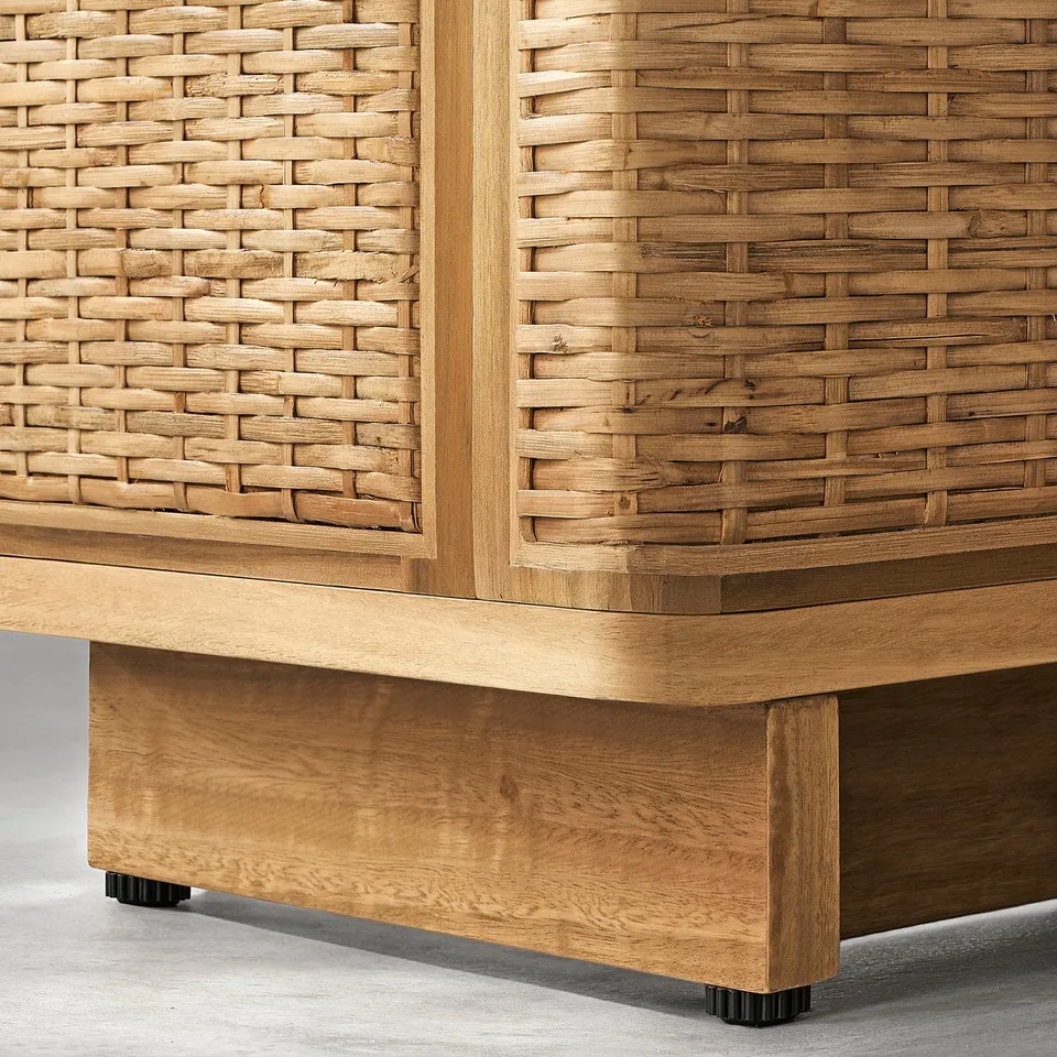 Close-up of woven rattan and wooden cabinet. Highlights intricate weaving and sturdy wooden structure.