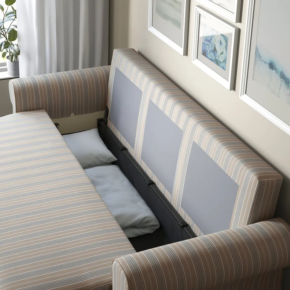 Sofa-bed with hidden storage opened, revealing pillows and bedding.