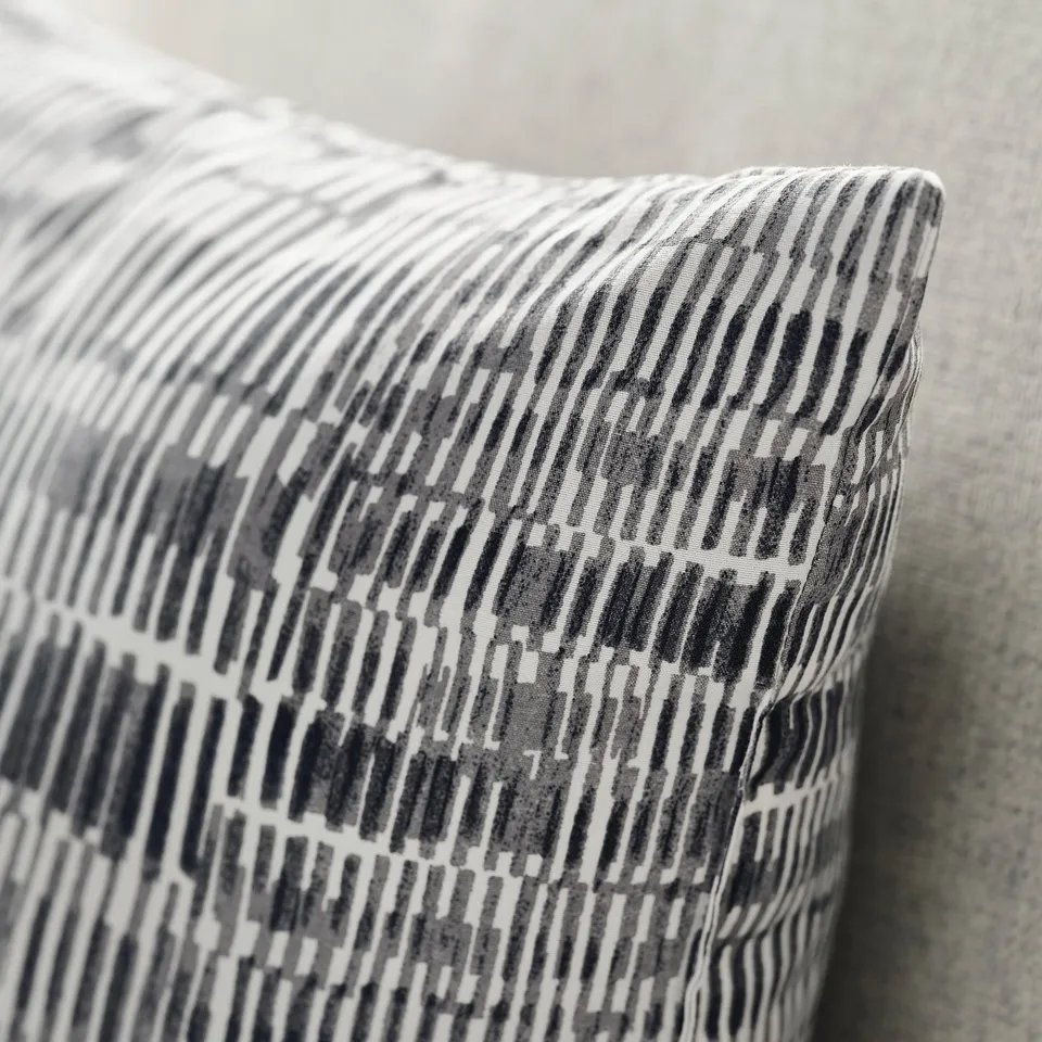 Black and white patterned pillow, soft texture, recycled polyester.