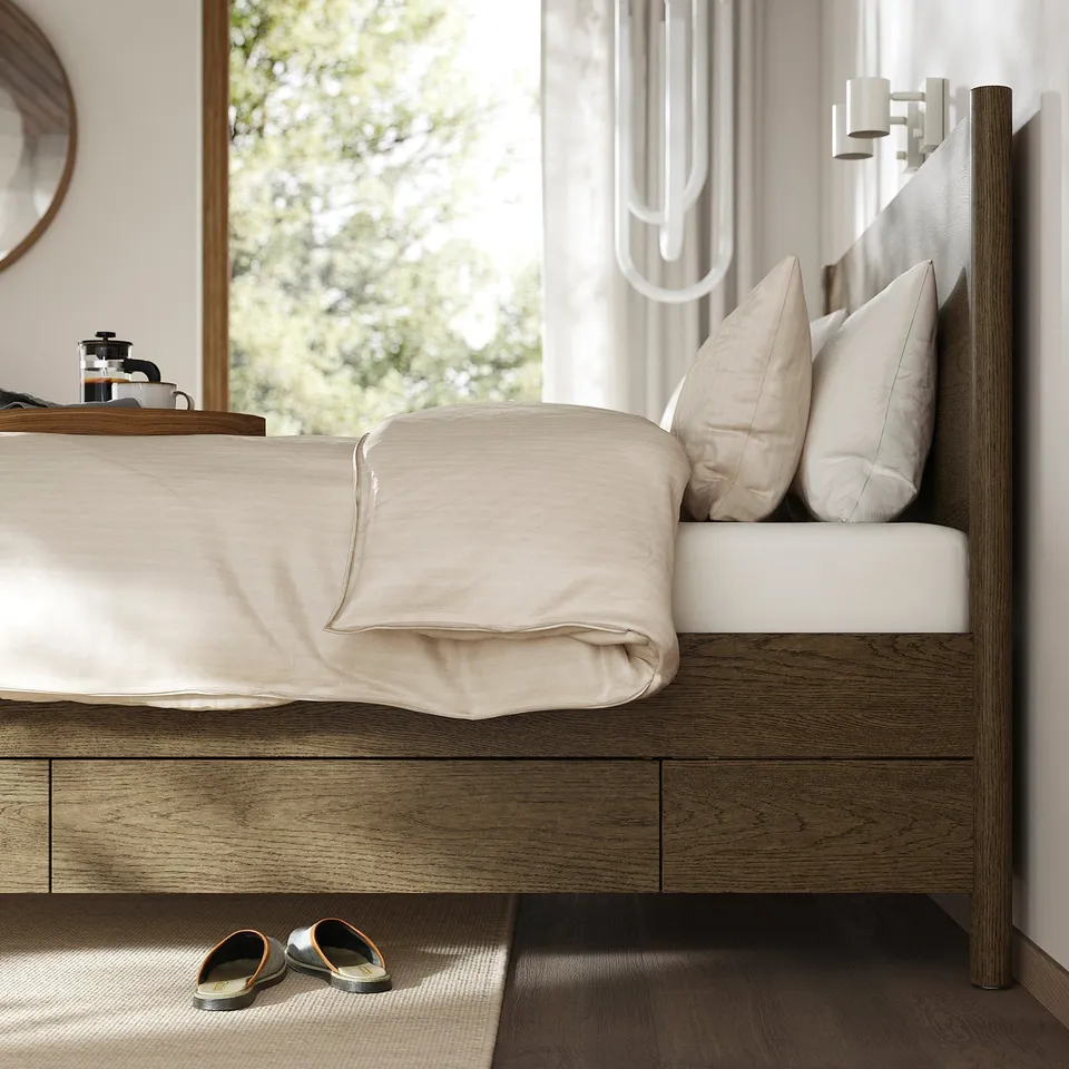 Minimalist bed with brushed veneer, soft-close drawers, and slatted base for air circulation, positioned near a large window with sheer curtains.