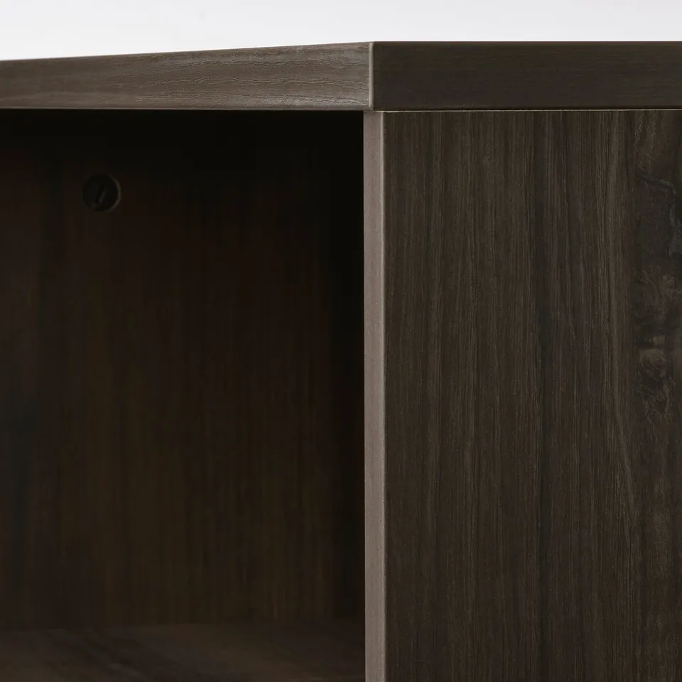 Dark wooden coffee table with sleek edges and open storage compartments.