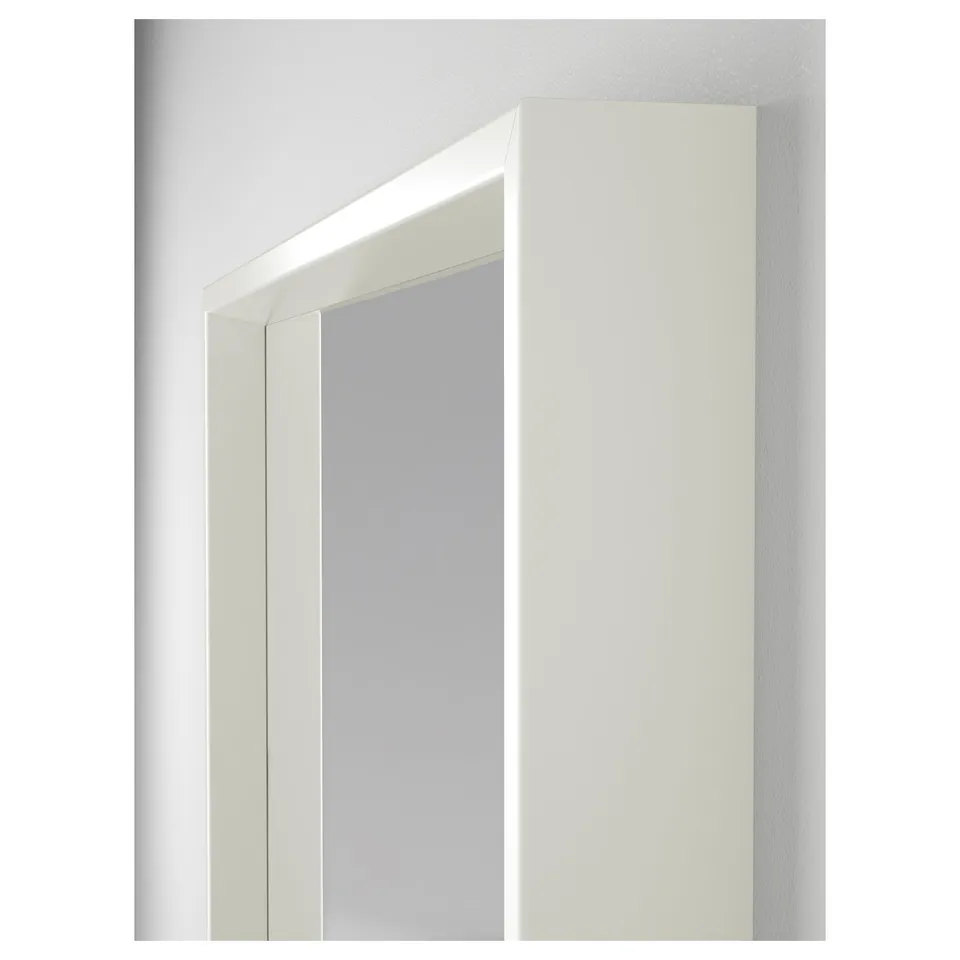 A sleek, modern mirror with a white frame mounted on a wall, showcasing high-quality design and construction.