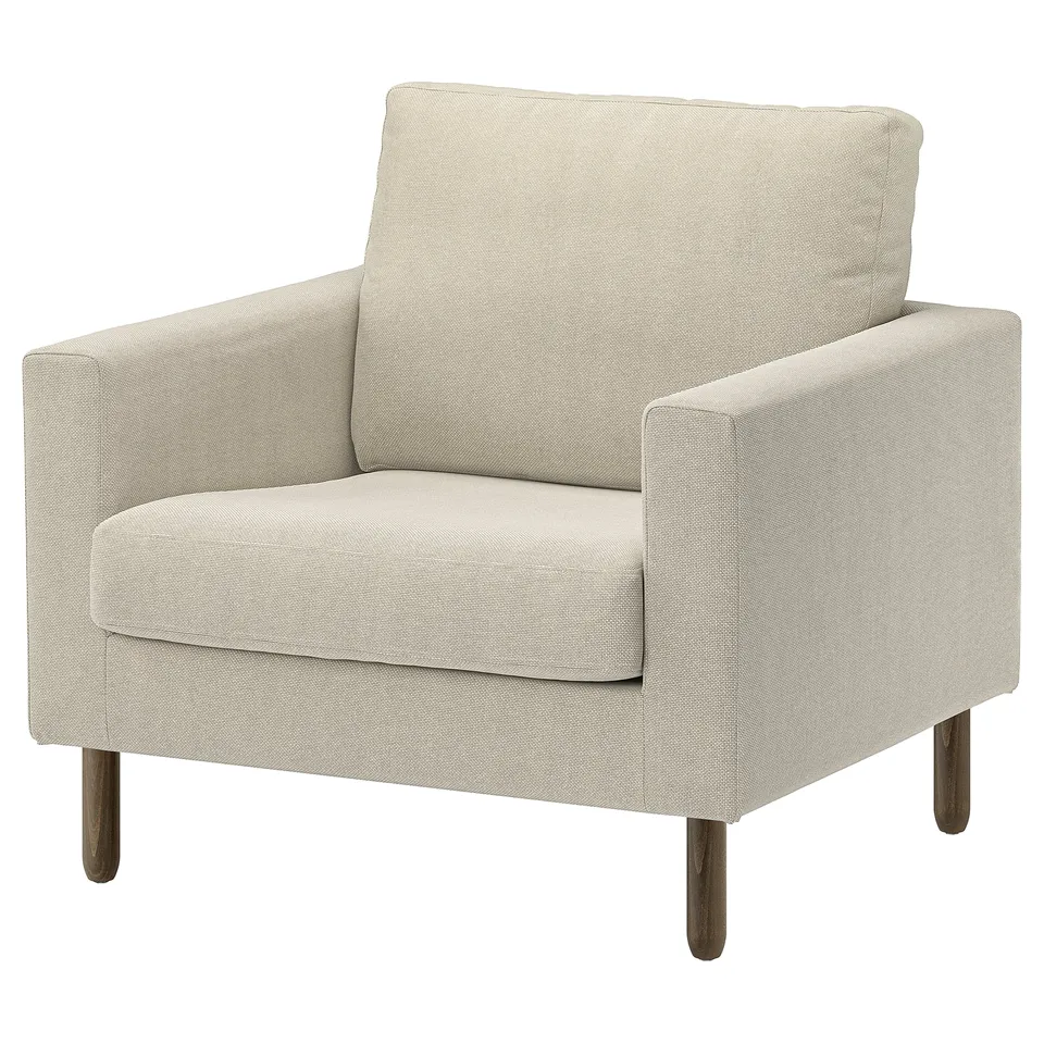 A SALTSJÖBADEN armchair in beige. It a minimalist design with wooden legs and a cosy, cushioned seat for comfort.