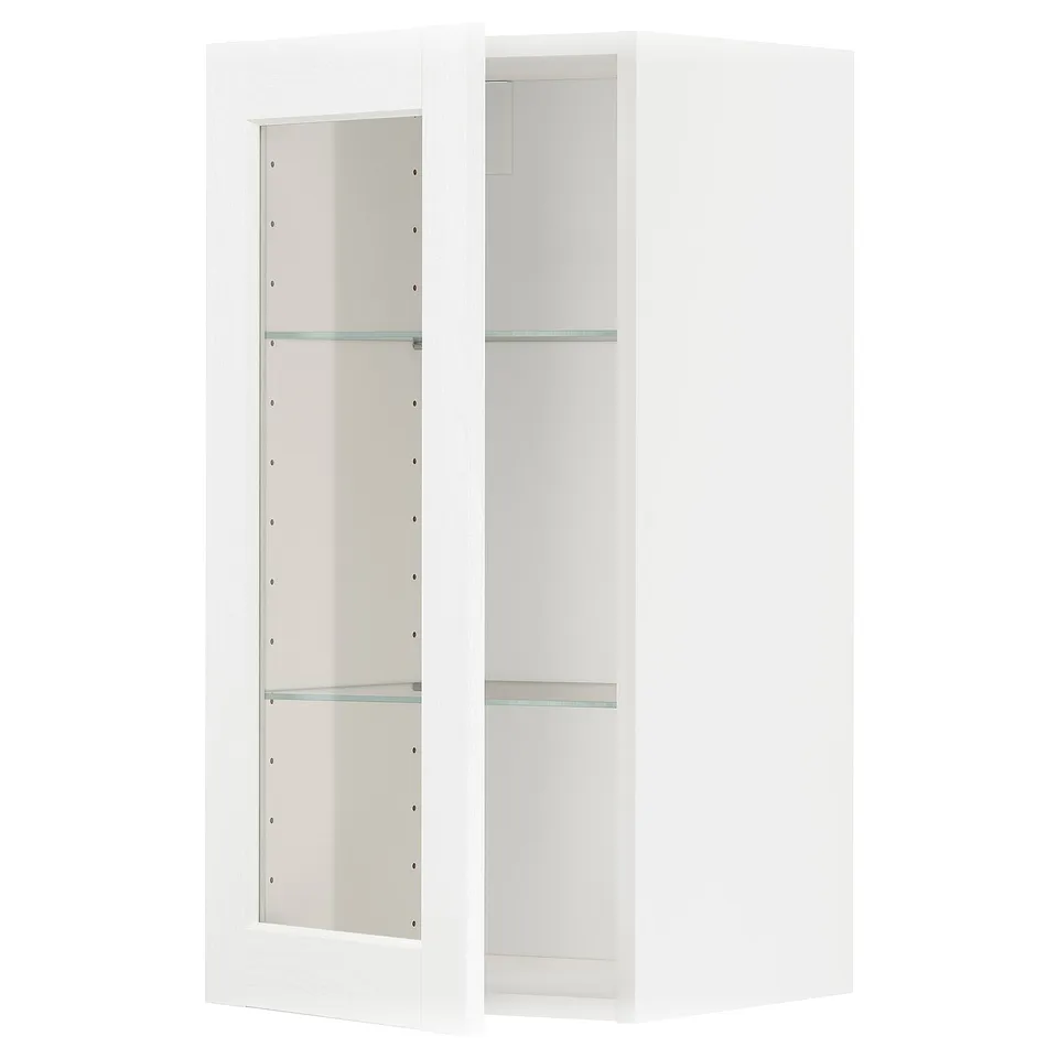 A white METOD kitchen cabinet with glass doors and adjustable shelves.