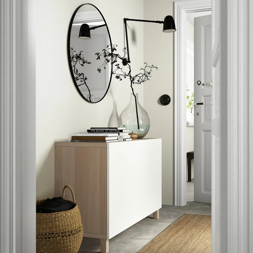 Entryway console table with adjustable shelves, soft-close doors, and wall-mounted light.