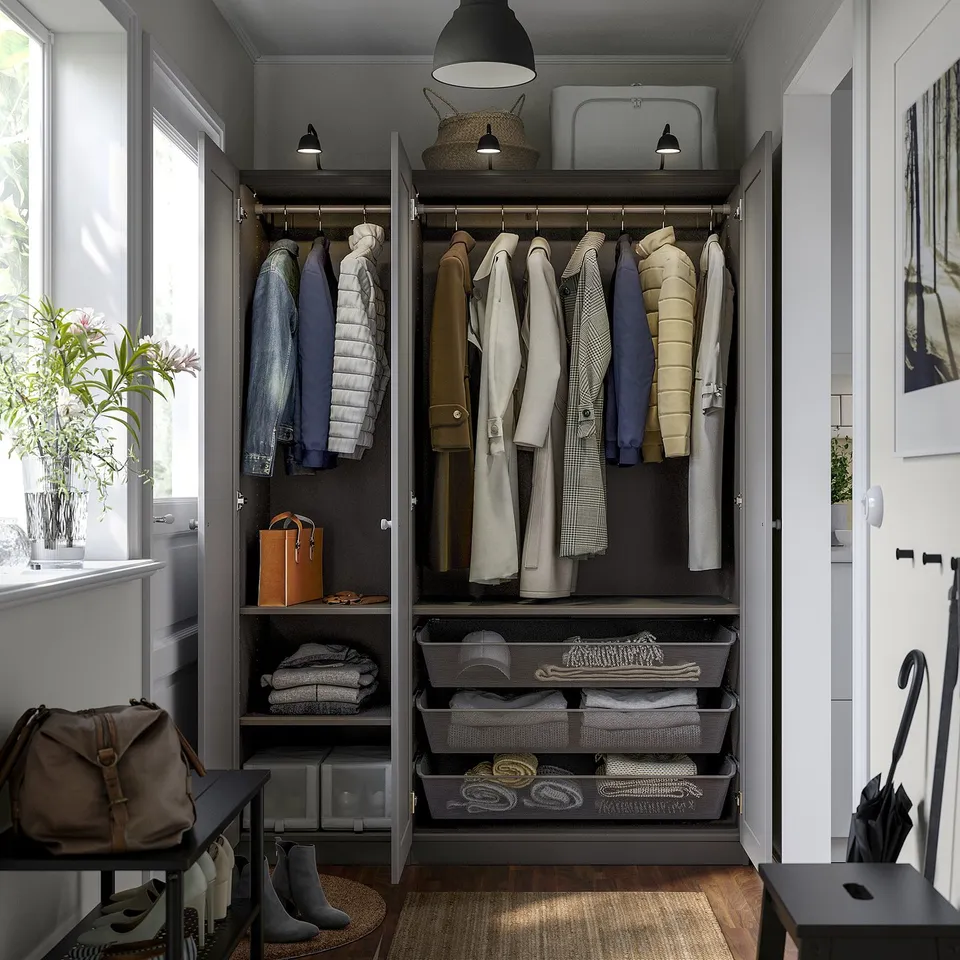 Open wardrobe with clothes and accessories neatly organised. Includes shelves, hanging space, and mesh drawers for storage.