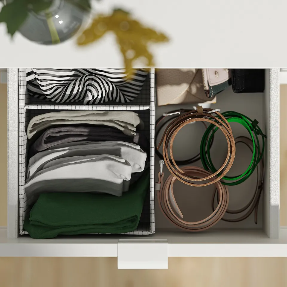 Organised drawer with stacked scarves and headbands. Closed drawers lock automatically for safety.