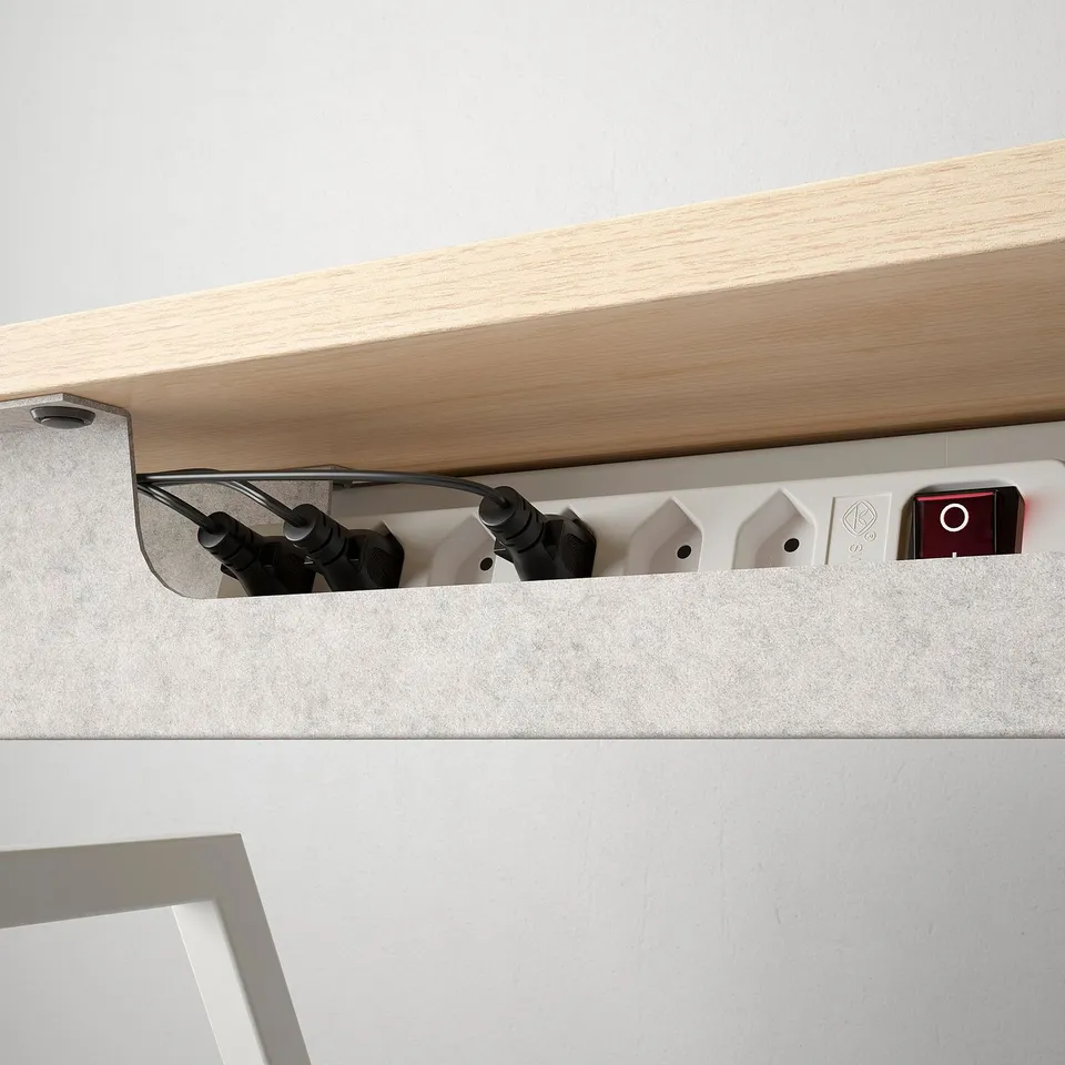Desk with cable management tray and safety lock, showcasing organised workspace.