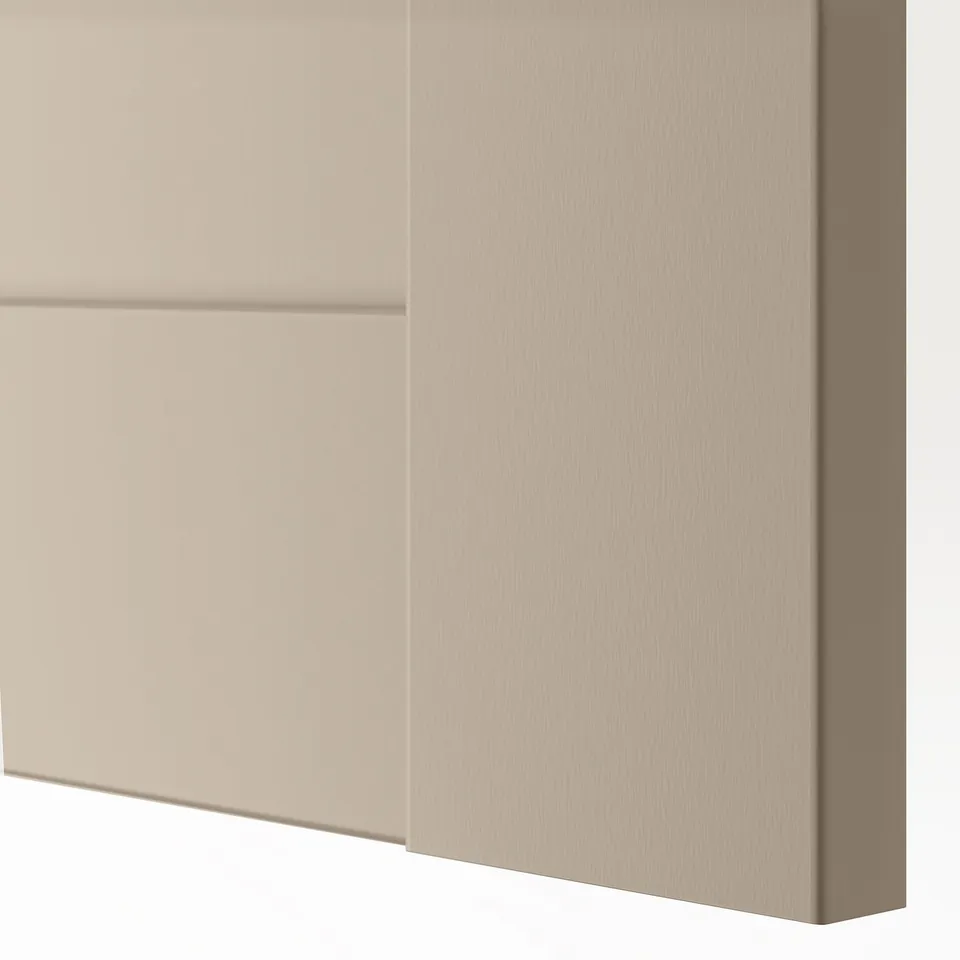 Close-up of a smooth, beige-colored, modern cabinet door with a sleek, square design.