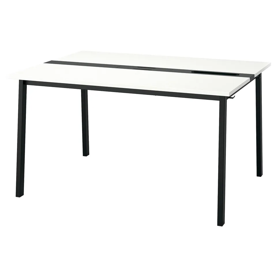 The MITTZON table a white fibreboard top and black metal legs, creating a sleek and modern design.