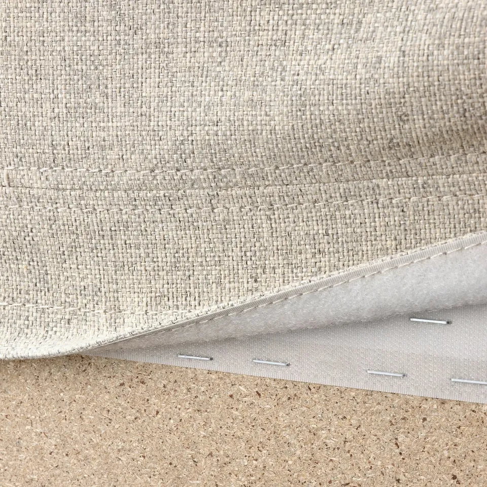 This photo shows a close-up of VIMLE sofa fabric, highlighting its removable, machine-washable cover with a durable stitching edge.