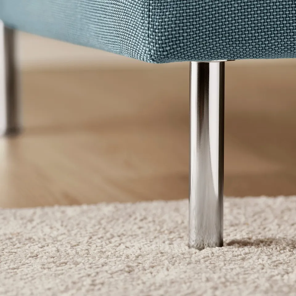 Modern chair leg detail, polished metal base, durable blue textured fabric.