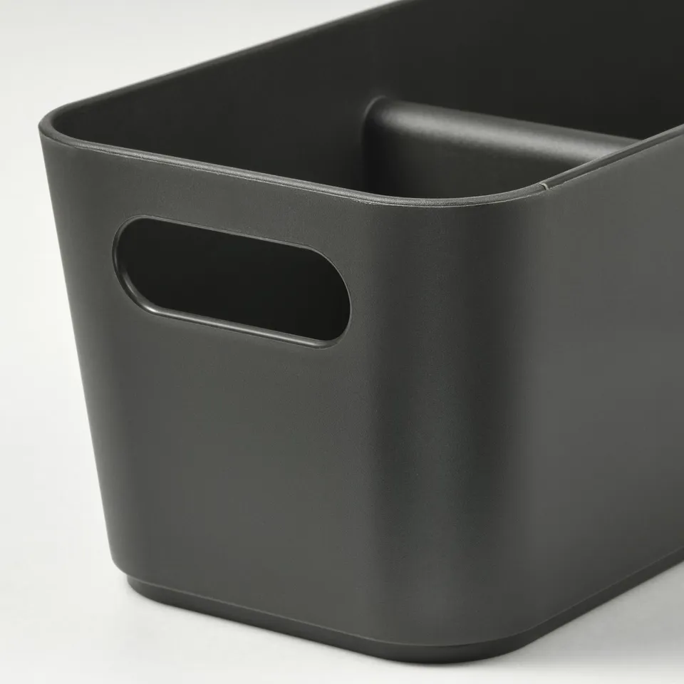 Black rectangular storage bin with rounded corners and two handles for easy carrying. One handle on top, one on side. Cutout design for grip.