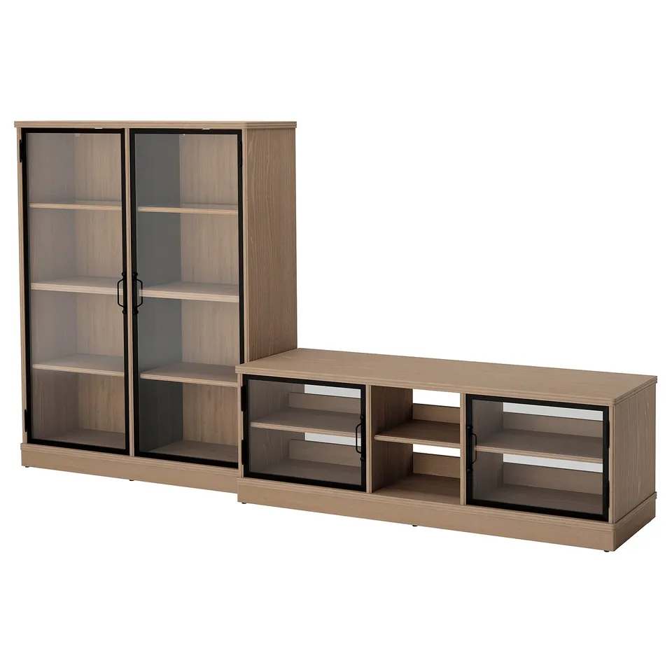 A wooden furniture set including a bookcase and tv bench with glass doors. Items are light brown with black accents.
