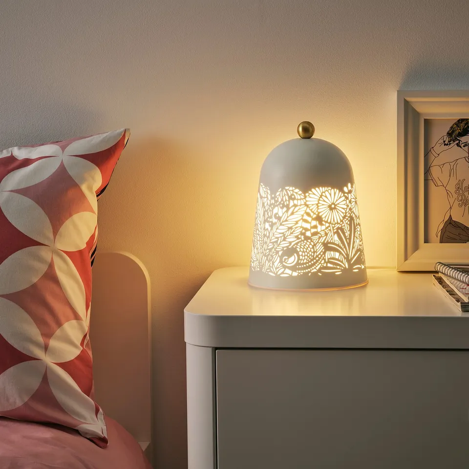 Cosy bedside lamp emits soft light, enhancing rooms ambiance. Place on bedside table next to bed.