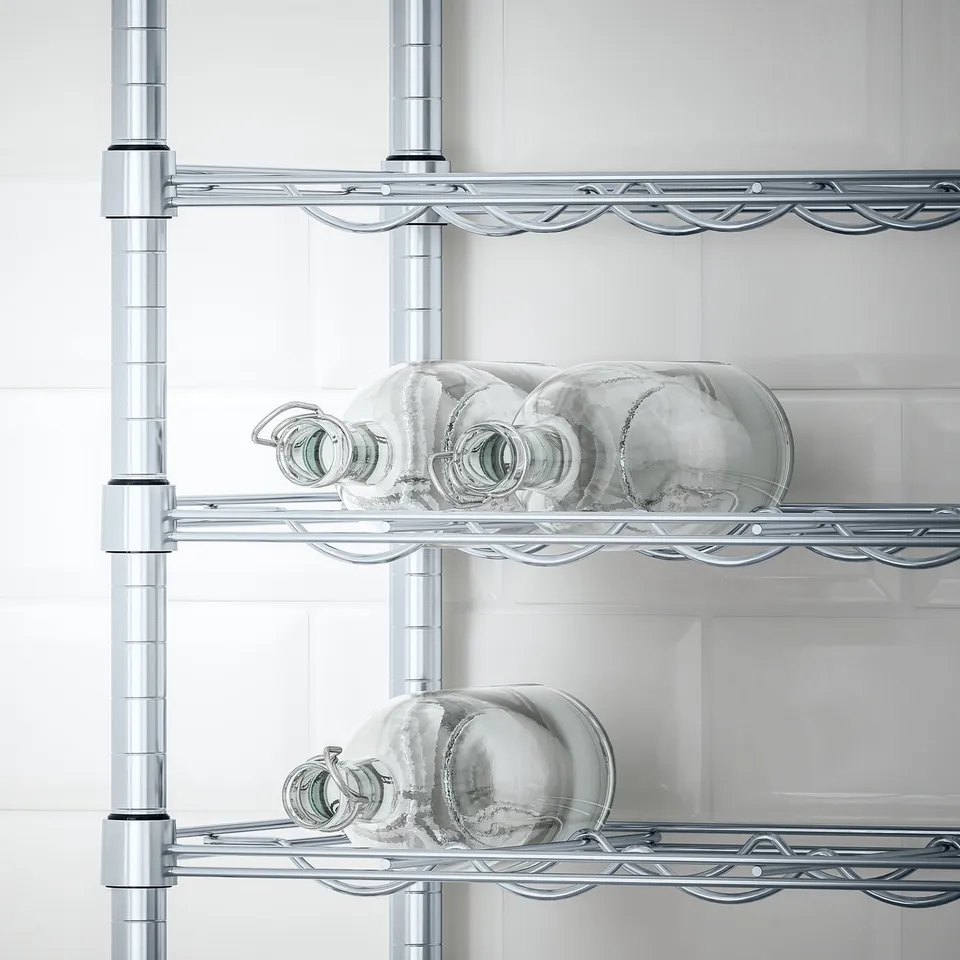 Silver wire shelving unit holding frosted glass bottles, designed for stability on uneven floors and suitable for damp indoor areas.