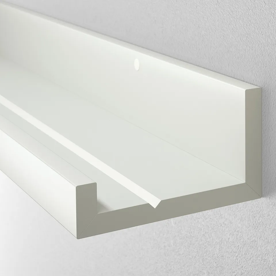 White wall shelf, neatly mounted, with a groove for picture frames, shown against a plain wall.
