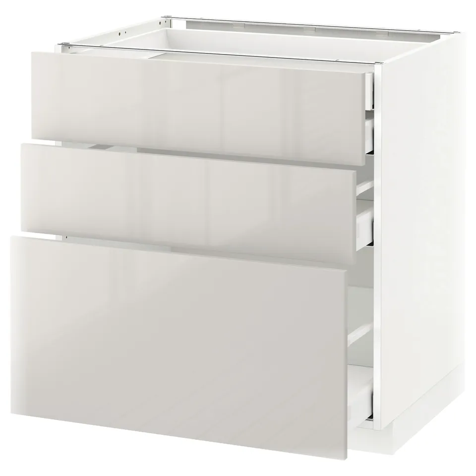 A white METOD kitchen unit with three drawers. Modern, high-gloss design, and durable construction.