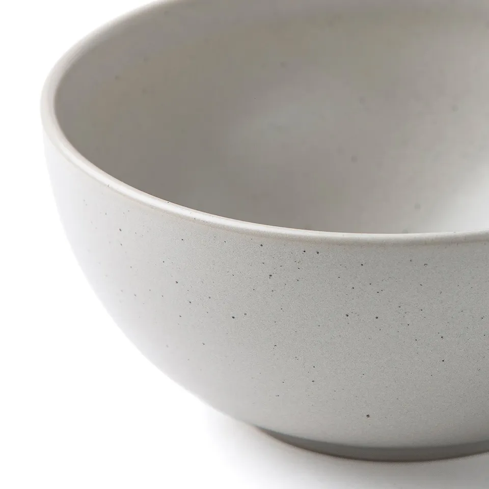 Speckled bowl, black dots on cream.