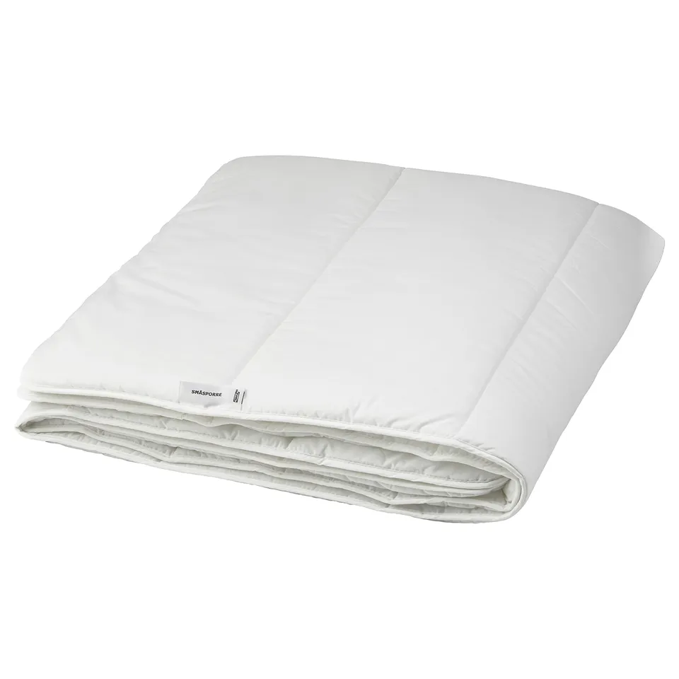 White folded bed comforter,ing includes polyester and cotton materials, plain design.