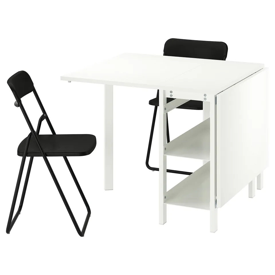 White VIHALS foldable table and black chairs. Modern, space-saving design. Table has adjustable shelves.