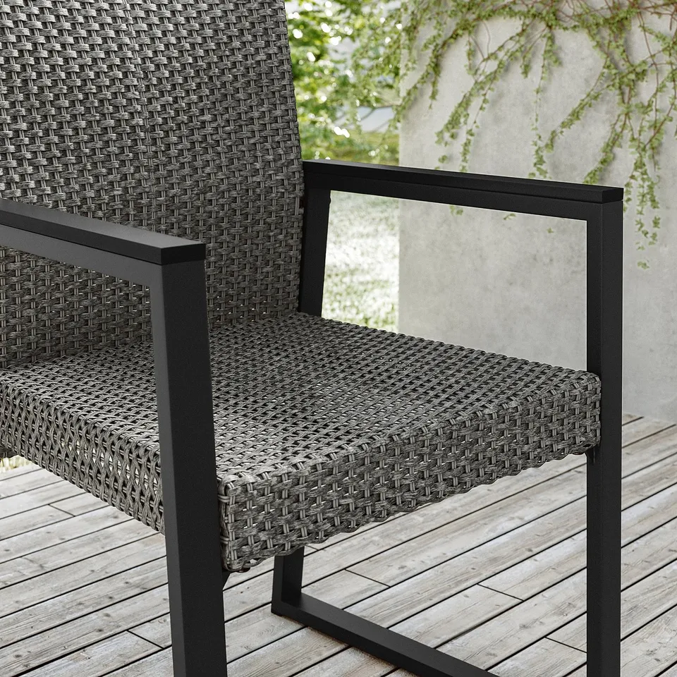 Modern black outdoor chair with woven seat and back, metal frame, curved armrests.