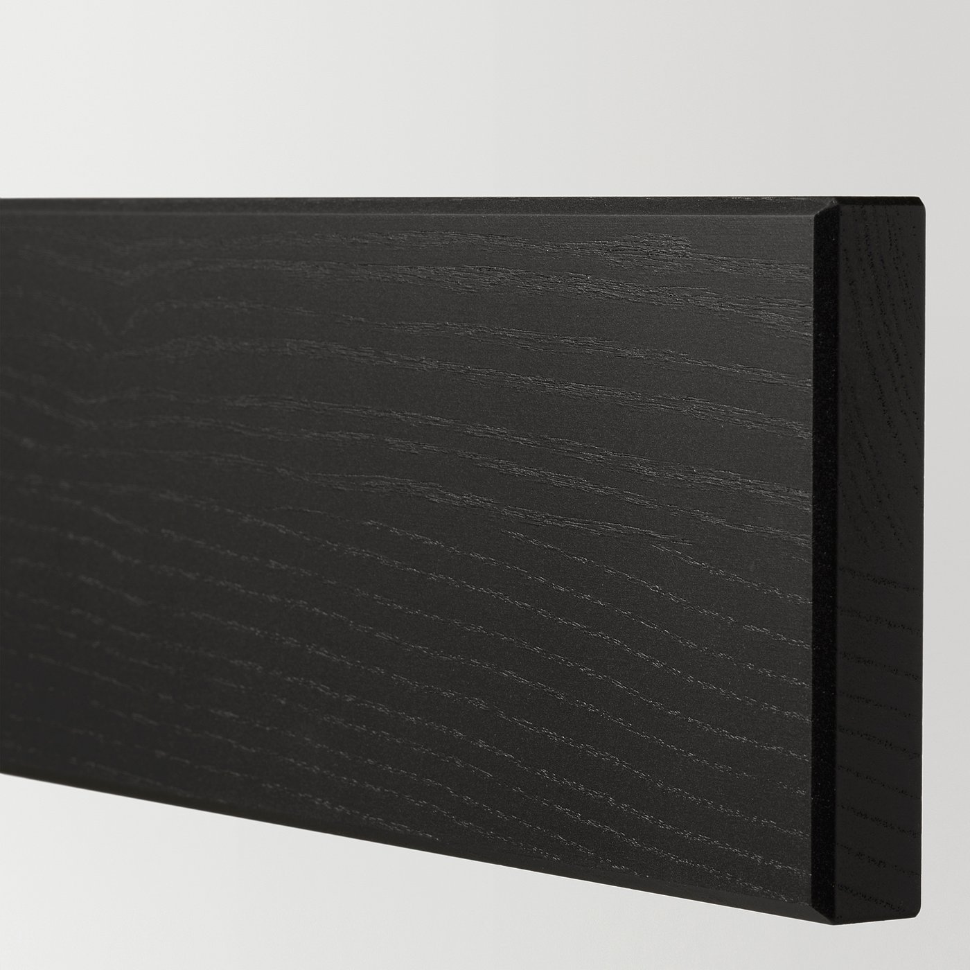 Black wooden panel with smooth, bevelled edges and a glossy finish. Vertical wood grain pattern is visible.