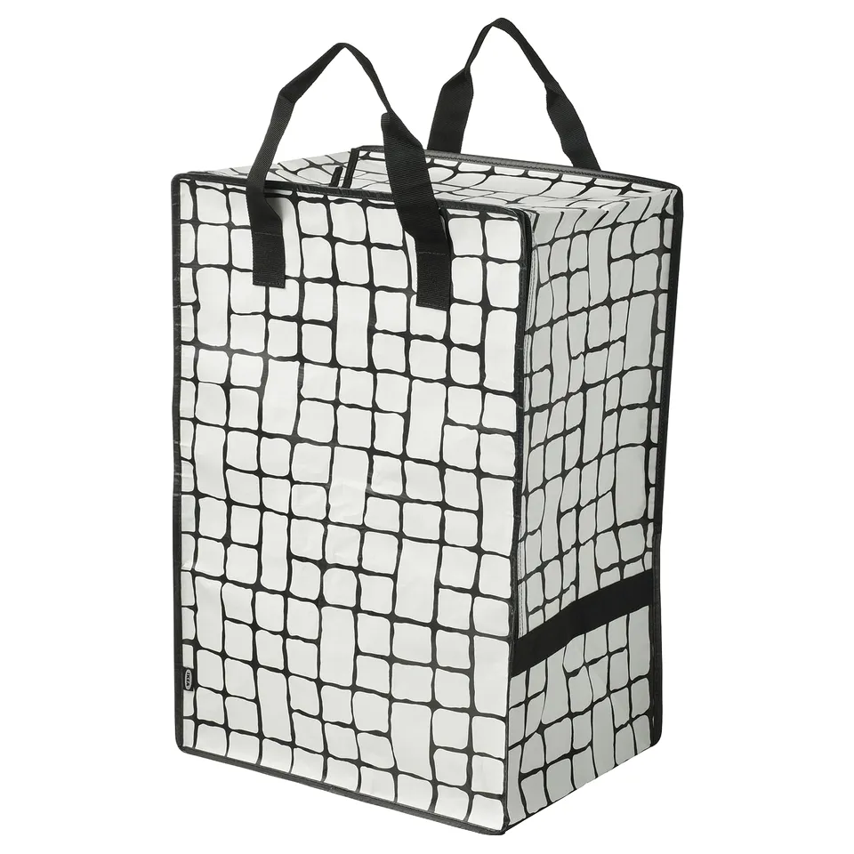 A black and white ikea GÖRSNYGG storage bag with a grid pattern, featuring sturdy handles and a zipper on the front.