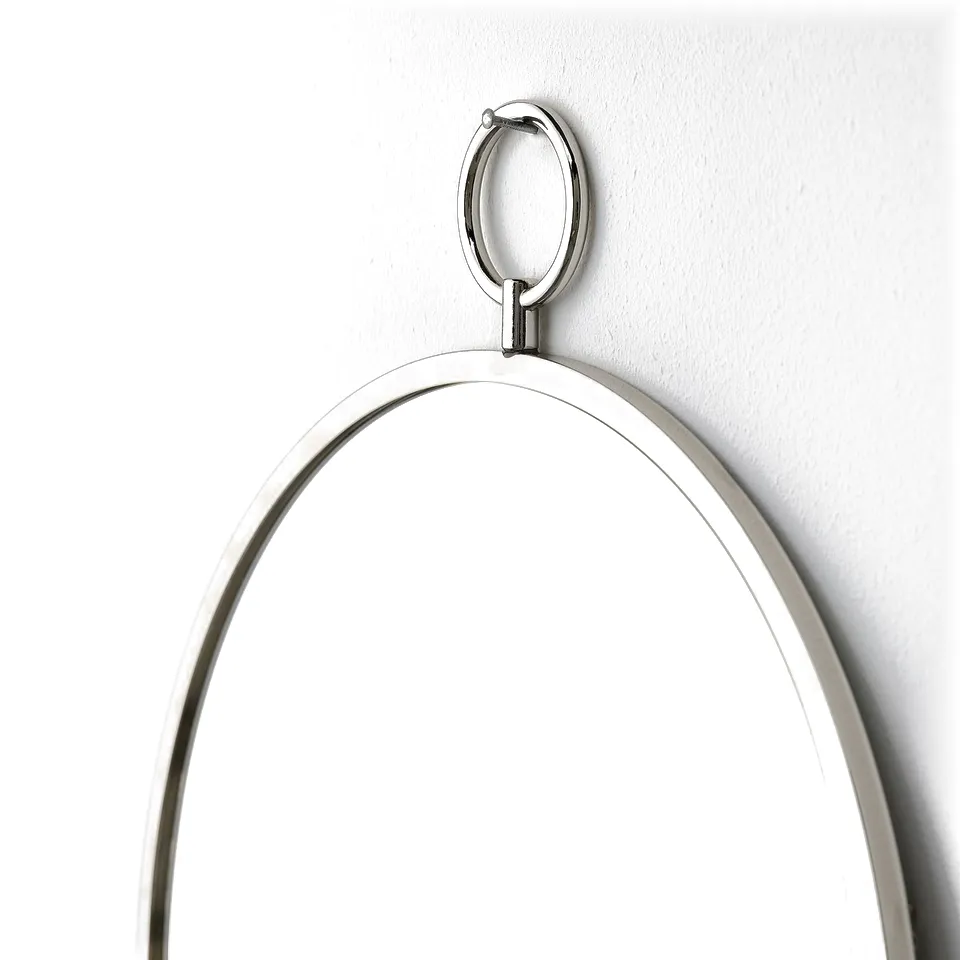 A sleek, round mirror with a polished nickel frame hangs on a wall, reflecting light for a bright, modern look.