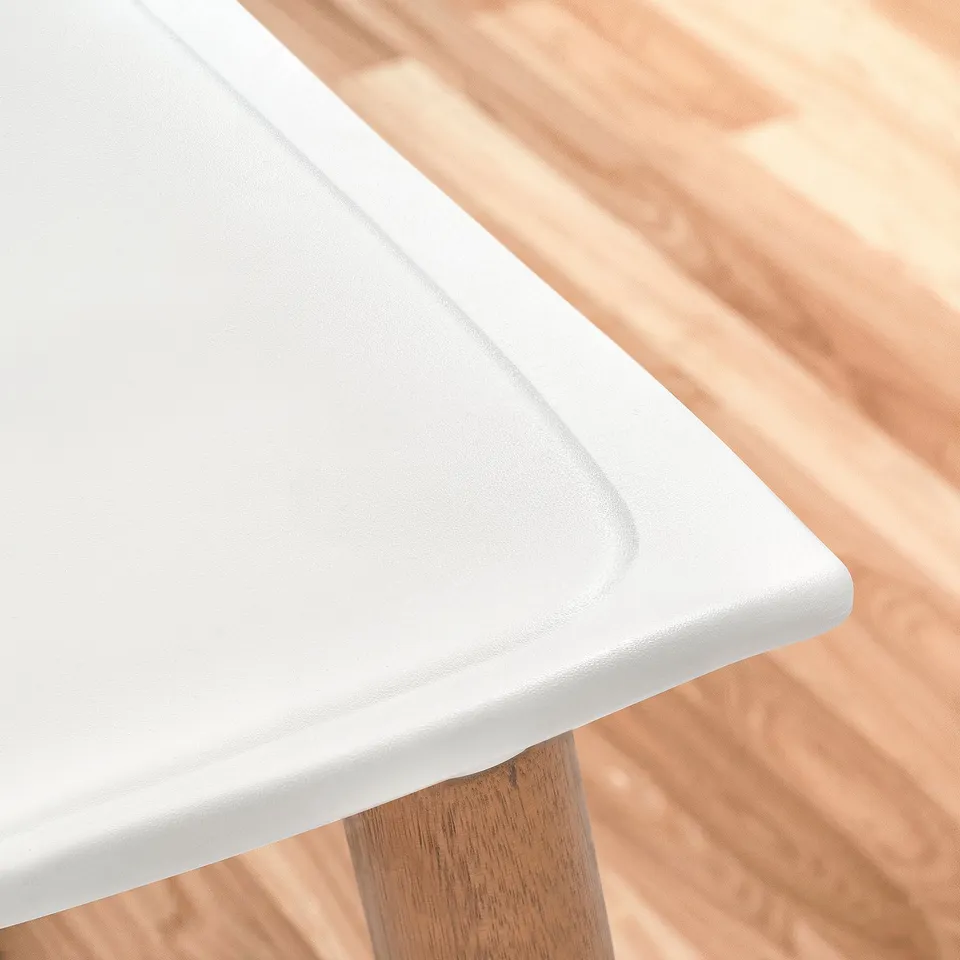 Close-up of GRÖNSTA stools smooth white seat and sturdy wood leg.