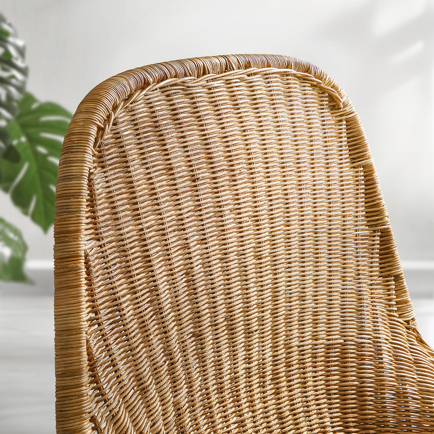Rattan armchair close-up, woven tightly and evenly. Comfortable and stylish, natural material.