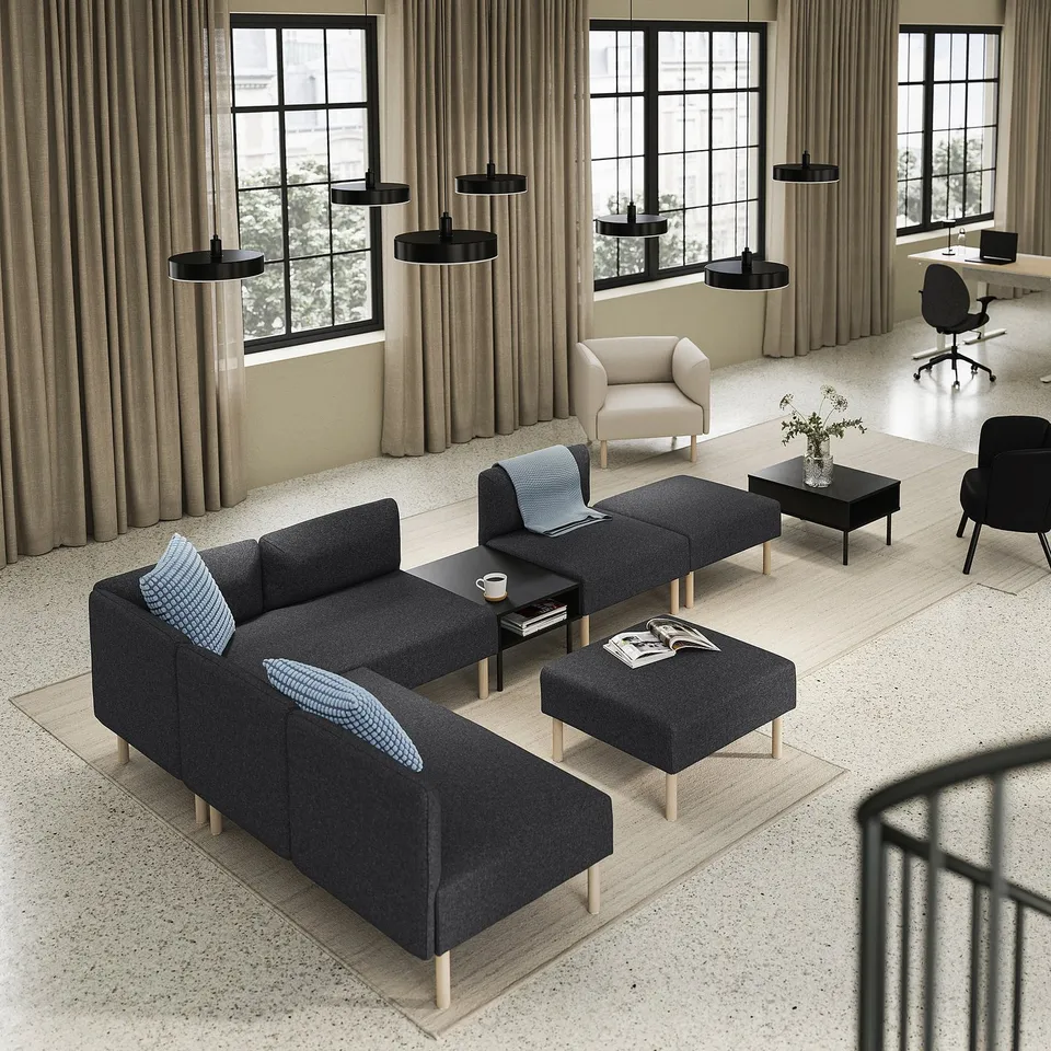Modern living room with LILLEHEM sofa, ottomans, coffee table, armchair, large windows & office space.