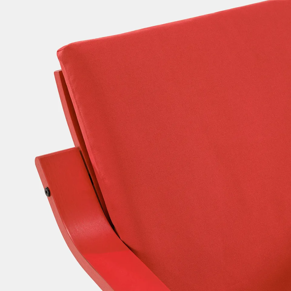 Bright red, modern, curved chair with smooth fabric, emphasising comfort and style.
