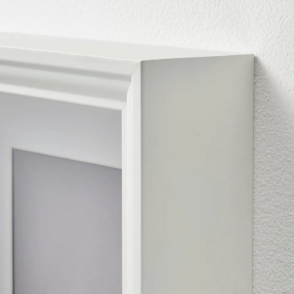 A close-up of a white picture frames corner, showing quality craftsmanship, smooth edges, and sturdy design.