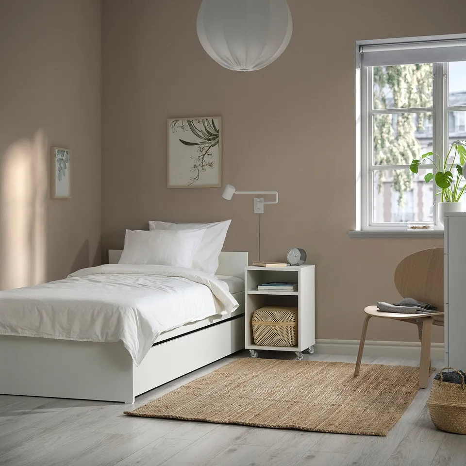Cosy bedroom with VIHALS white bed frame, minimalist decor, chair, & plants.